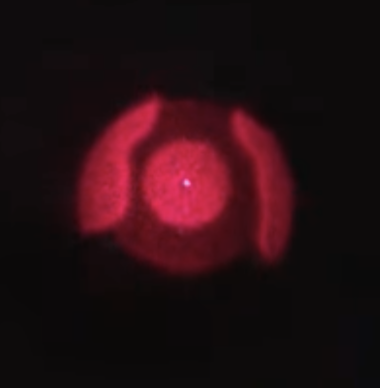 Fresnel zone plate used in the lecture (left), which actually cracked due to the heat of the light source a second later. The Fresnel zone plate creates a focal point as visible on the right (bright spot in the center).